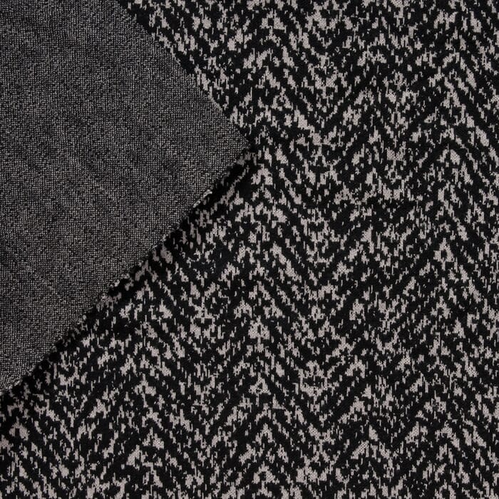 Schurwolle Strickstoff weißes grafisches Muster auf schwarz 