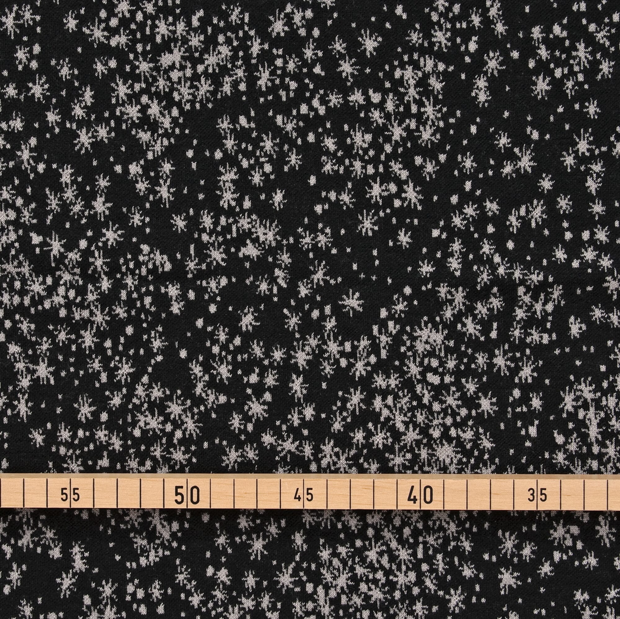 Schurwolle Strickstoff weiße Sterne auf schwarz